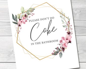 May include: A white print with the text "PLEASE DON'T DO Coke IN THE BATHROOM" in a black script font. The text is surrounded by a gold geometric frame and floral accents. The words "DIGITAL DOWNLOAD" are at the top.