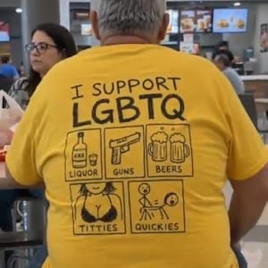 May include: A yellow short-sleeved t-shirt featuring black text that reads I SUPPORT LGBTQ above five square illustrations labeled LIQUOR, GUNS, BEERS, TITTIES, and QUICKIES, depicting a bottle, a handgun, two beer mugs, a person, and stick figures.