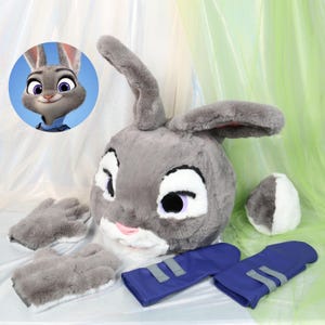 May include: A gray plush bunny head with large ears, white accents, and purple eyes, along with matching gray gloves, a tail, and blue arm coverings. A cartoon image of the bunny is in the upper left corner. The set is designed for cosplay or costume use.