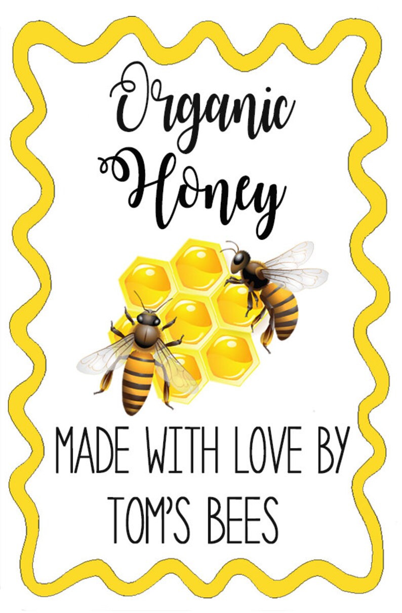 May include: A yellow and white label with a wavy border. The label says "Organic Honey" in black cursive text. There are two cartoon bees on the label, one on each side of a honeycomb. The text "Made with Love By Tom's Bees" is below the honeycomb.