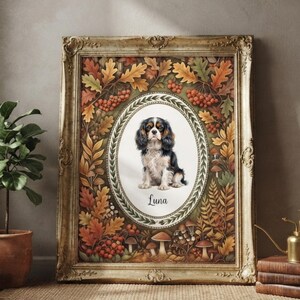 May include: A framed rectangular wall art piece featuring a central oval portrait of a tricolor Cavalier King Charles Spaniel dog. Below the dog, the name Luna is written in script. The border displays autumn leaves, berries, and mushrooms.