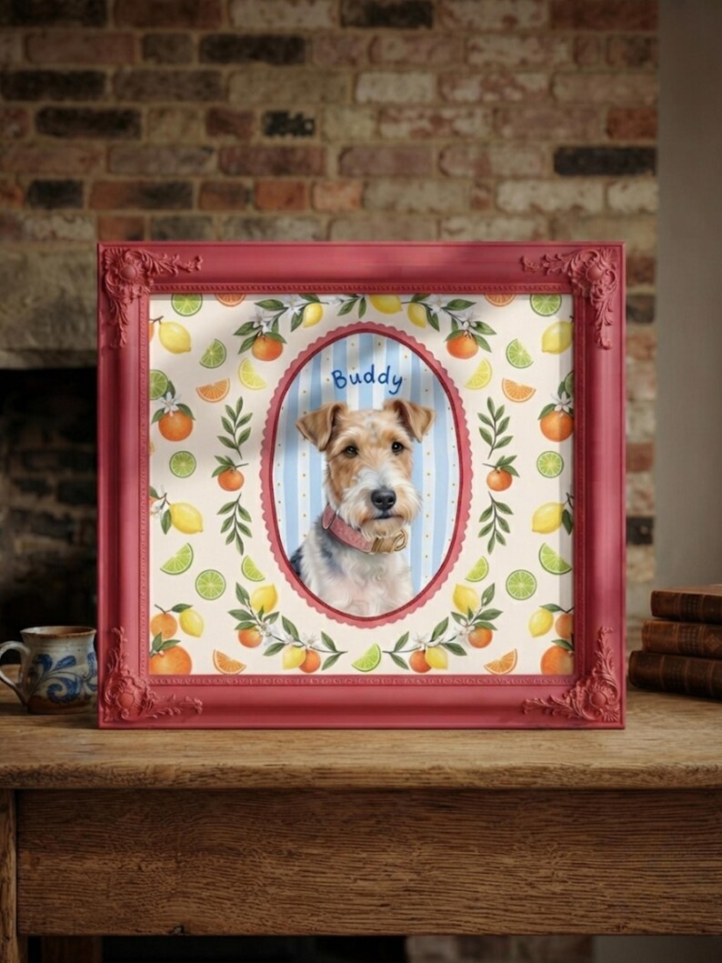 May include: A square red ornate frame containing a portrait of a wire-haired terrier dog wearing a pink collar. The dog is centered in an oval frame against a blue and white striped background with the name Buddy written above the dog's head.