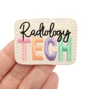 May include: A white, glittery patch with the text "Radiology TECH" in colorful embroidered letters. The letters are pink, orange, purple, and green.
