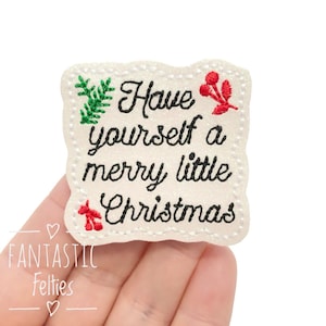 May include: A cream-colored felt patch with the embroidered phrase "Have yourself a merry little Christmas" in black script. The patch is decorated with green and red embroidered accents, and has a scalloped edge.