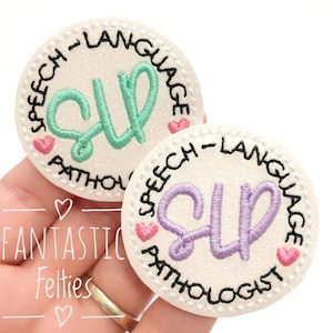 May include: Two white, round, glittery patches with black stitching. Each patch has the letters "SLP" in a different color, green and purple. The text "Speech-Language Pathologist" is written around the outside of each patch.