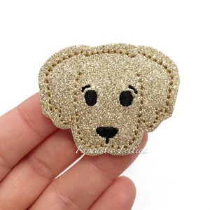 May include: Gold glitter felt dog applique with black embroidered eyes, nose, and mouth.