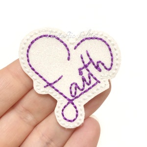 May include: Purple embroidered felt heart with the word "Faith" inside.