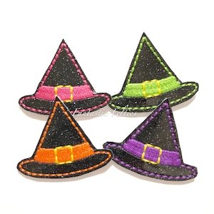 May include: Four glittery black witch hats with colorful bands in pink, green, orange, and purple. Each hat has a gold buckle and is outlined with a contrasting stitch. The text "Fantastic Felties" is visible.