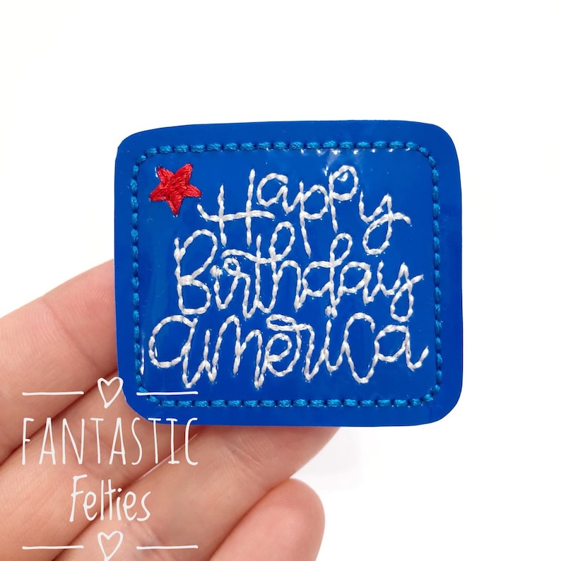 May include: Blue felt patch with white embroidery that says "Happy Birthday America" and a red star in the top left corner.