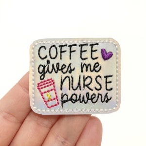 May include: Embroidered patch with the text "COFFEE gives me NURSE powers". The patch features a coffee cup graphic and a purple heart. The patch has a white border and the words "Fantastic Felties" are at the bottom.
