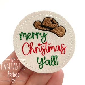 May include: White felt circle with a brown cowboy hat, red text that says "merry Christmas" and green text that says "y'all".