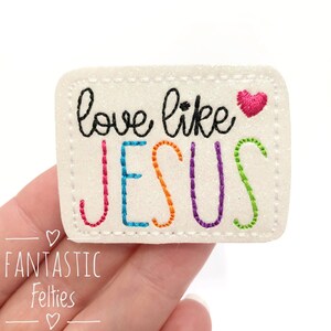 May include: White felt patch with the text "love like JESUS" in rainbow colors and a small pink heart.