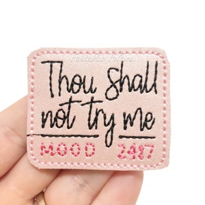 May include: Pink felt patch with black stitching and the text "Thou Shall Not Try Me Mood 24/7".