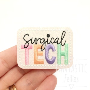May include: White felt patch with a black embroidered outline. The text "Surgical Tech" is embroidered in colorful letters. The letters are pink, orange, purple, and green.