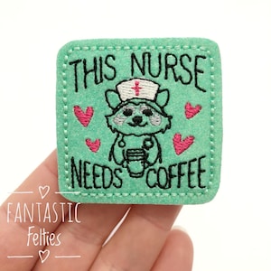 May include: Green felt patch with embroidered text "This Nurse Needs Coffee" and a cartoon raccoon wearing a nurse's hat and holding a cup of coffee.