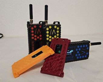 May include: A collection of black, red, and yellow electronic devices with antennas. The devices have a honeycomb pattern and the text "MESTASTIC" is visible. There are also orange and red covers.