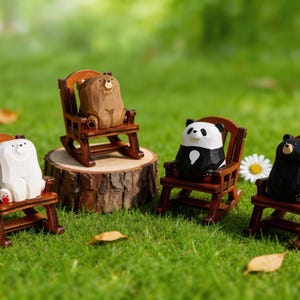 May include: Four wooden bear figurines in rocking chairs on a grassy lawn. The bears are white, brown, black, and panda-colored. The chairs are brown, and one bear sits on a wooden stump. Daisies and fallen leaves are scattered around.