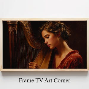 May include: A framed art print featuring a woman playing a harp. The woman is wearing a red dress and is in profile, with her face illuminated. The harp is a golden brown color. The text "Frame TV Art Corner" is at the bottom.