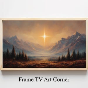 Puede incluir: Una pintura de paisaje enmarcada representa una cordillera bajo un cielo dorado, con una estrella brillante en el centro. La obra de arte presenta un valle con árboles en primer plano. El marco es de madera clara. El texto "Frame TV Art Corner" está en la parte inferior.