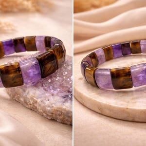 May include: A bracelet featuring alternating rectangular beads of purple amethyst and brown tiger's eye. The gemstone bracelet is displayed on a light-colored surface, showcasing the natural colors and textures of the stones. Additional loose amethyst stones are also present.