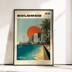 May include: A framed art print showing a stylized illustration of Colombo, Sri Lanka. The artwork features a cityscape with a large orange sun, palm trees, and a beach. The text "COLOMBO SRI LANKA" is at the top, with coordinates at the bottom.