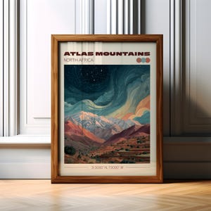 May include: A framed print featuring a landscape of the Atlas Mountains in North Africa. The artwork showcases a colorful depiction of the mountains under a starry night sky. The print includes the text "ATLAS MOUNTAINS NORTH AFRICA" and coordinates.