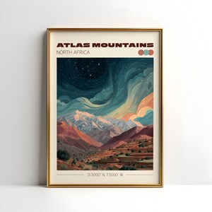 May include: A framed art print featuring a landscape of the Atlas Mountains in North Africa. The artwork depicts a mountain range under a starry night sky with swirling clouds in shades of blue, orange, and white. The print includes the text "ATLAS MOUNTAINS NORTH AFRICA" and coordinates.