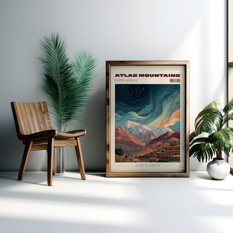 May include: A framed art print featuring a landscape of the Atlas Mountains in North Africa. The artwork displays a colorful depiction of mountains under a starry sky. The print is in a wooden frame and is displayed with a wooden chair and plants.