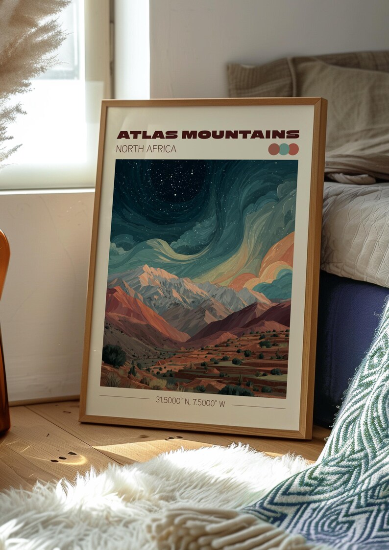 May include: Framed art print featuring a colorful landscape of the Atlas Mountains in North Africa. The artwork depicts a mountain range under a starry sky, with text that reads "Atlas Mountains North Africa" and coordinates. The frame is made of wood.