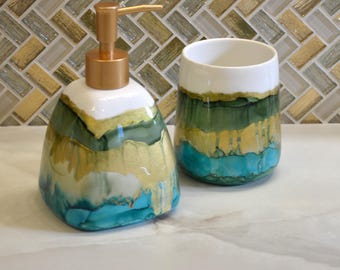 Hand painted bath vanity set in green and gold. Dispenser and brush holder.