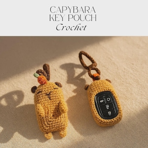 May include: Two crochet capybara key pouches. One is a capybara figure with antlers and a carrot, the other is a key fob cover. The text "CAPYBARA KEY POUCH Crochet" is at the top.