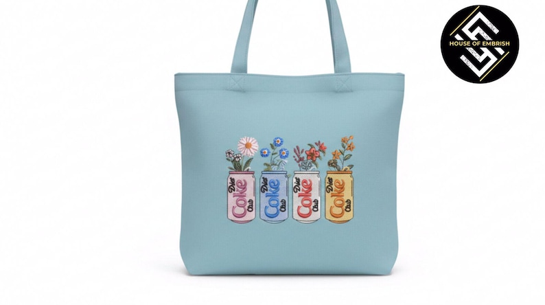 May include: Light blue tote bag featuring four embroidered soda cans, each holding a different arrangement of flowers. The cans are in pink, blue, red, and yellow, with the words "Coke" and "Diet Coke" on them.