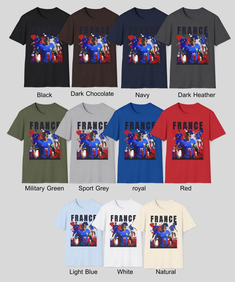 May include: A collection of short-sleeved t-shirts in various colors, each featuring a graphic of a soccer player and the word "FRANCE". Colors include black, dark chocolate, navy, dark heather, military green, sport grey, royal, red, light blue, white, and natural.