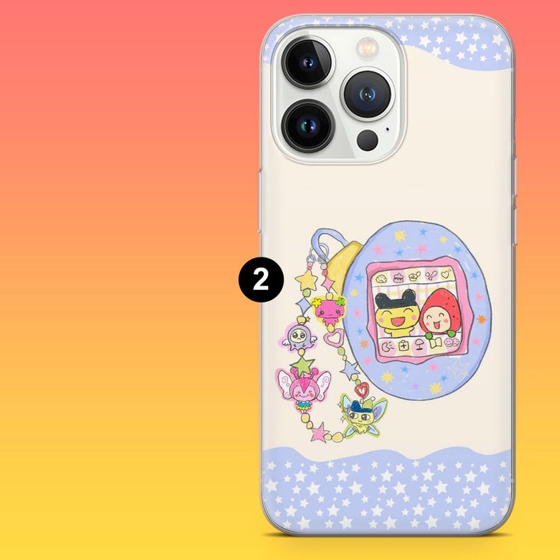 May include: A white phone case with a blue and white star pattern and a cartoon graphic of a handheld digital pet game. The case features a charm with various cartoon characters.