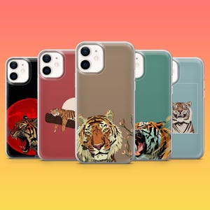 May include: A collection of phone cases featuring tiger illustrations. The cases display various tiger designs, including a roaring tiger, a tiger resting on a branch, and a tiger's face. The cases have a clear, protective design.