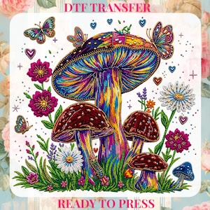 May include: A colorful DTF transfer design featuring a psychedelic mushroom scene with butterflies, flowers, and hearts. The design includes the text "DTF TRANSFER" and "READY TO PRESS". The mushrooms are in shades of red, purple, and blue.