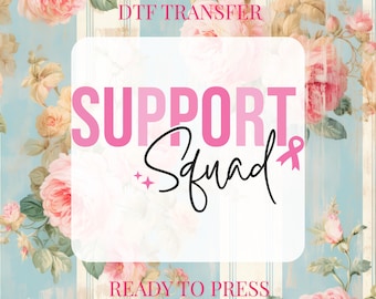 May include: A DTF transfer design with the words "SUPPORT Squad" in pink and black script, featuring a pink ribbon. The design is set against a floral background with pink roses and a light blue striped pattern. Text at the top reads "DTF TRANSFER" and at the bottom "READY TO PRESS".