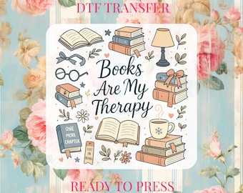 May include: DTF transfer design featuring the phrase "Books Are My Therapy" surrounded by illustrations of books, glasses, a lamp, and a coffee cup. The design includes the text "Ready to Press". The background has a floral pattern.