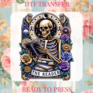 May include: DTF transfer featuring a skeleton reading a book, surrounded by flowers and celestial elements. The text "THE READER" is at the bottom. The words "DTF TRANSFER" and "READY TO PRESS" are at the top and bottom.