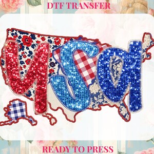 May include: DTF transfer design with the word "USA" in red and blue glitter, set over a map of the United States. The design includes floral, gingham, and lace patterns. The text "DTF TRANSFER" and "READY TO PRESS" are at the top and bottom.