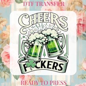 May include: A DTF transfer design featuring two green beer mugs clinking together, with the word "CHEERS" above and "F*CKERS" on a banner below. The design includes a shamrock and the text "READY TO PRESS".