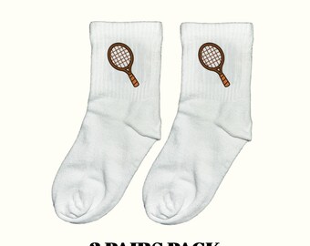 May include: Two pairs of white ankle socks, each embroidered with a brown tennis racket. The image includes the text "3 PAIRS PACK" in black. The socks are made from a soft, comfortable material, perfect for sports or casual wear.