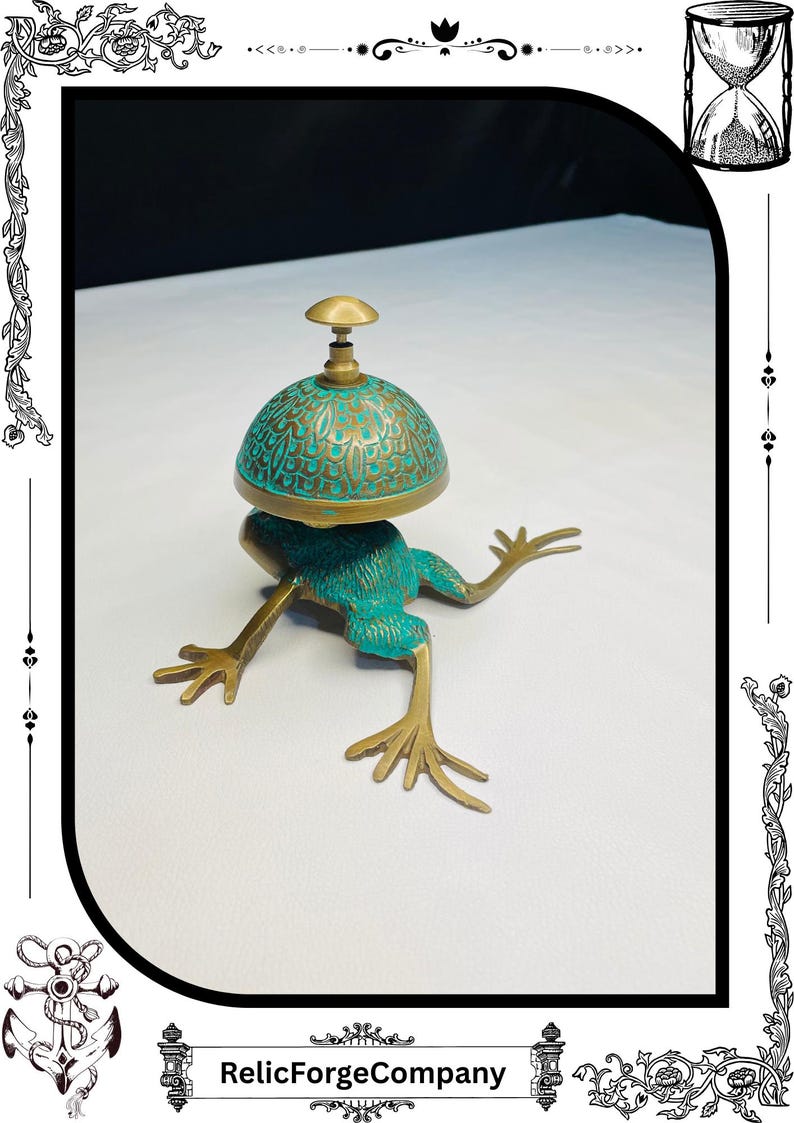 May include: A whimsical frog-shaped bell with a teal and gold finish. The bell has a dome-shaped top with an intricate design. The frog's body and legs are a bronze color. The bell is a decorative item.
