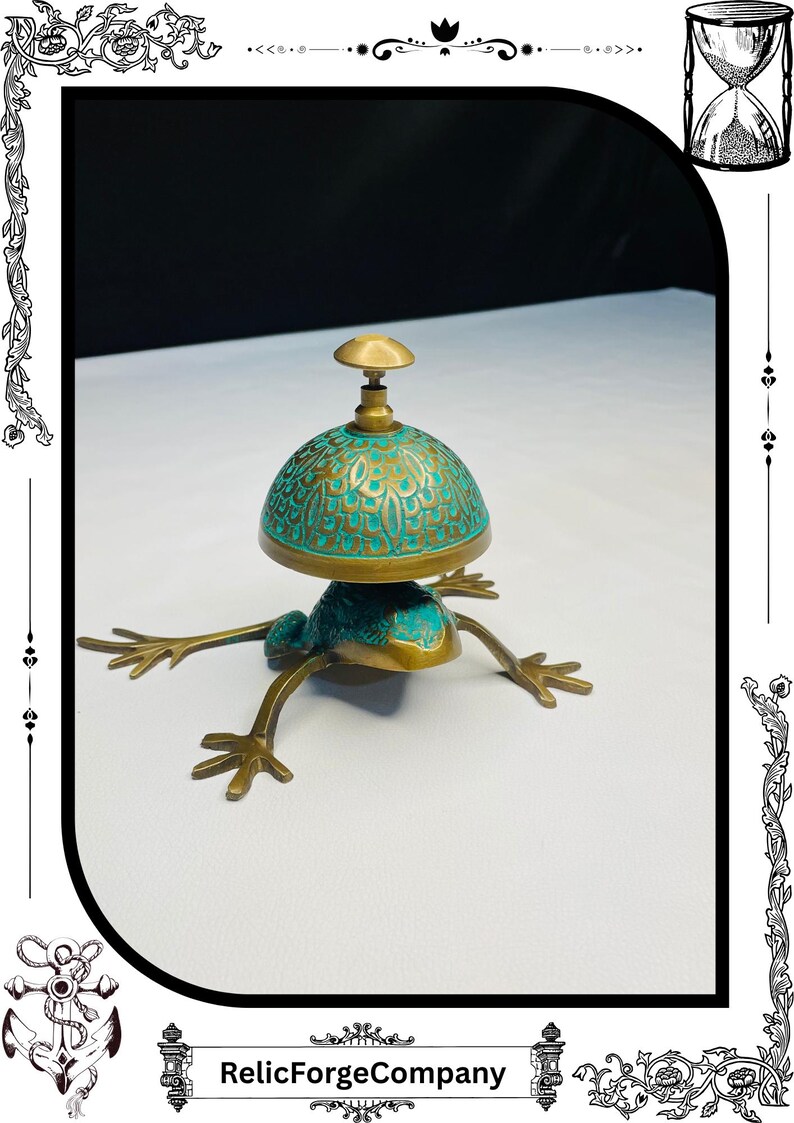 May include: A brass frog-shaped bell with a turquoise and gold dome. The bell has a detailed design and is set on four outstretched legs. The top of the bell has a small brass knob. The base of the image has the text "RelicForgeCompany".