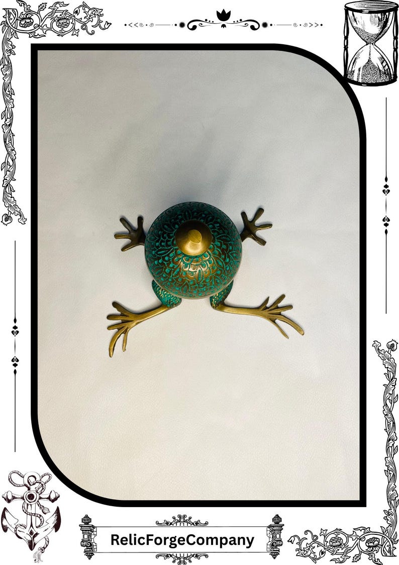 May include: A decorative frog sculpture with a verdigris finish and brass accents. The frog has a round body with intricate patterns and outstretched legs. The sculpture is a unique home decor item.
