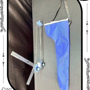 May include: A blue bag with a black strap and a drafting tool with a clear ruler and blue components. The drafting tool is connected to a blue mechanism with dials. The logo "RelicForgeCompany" is at the bottom.