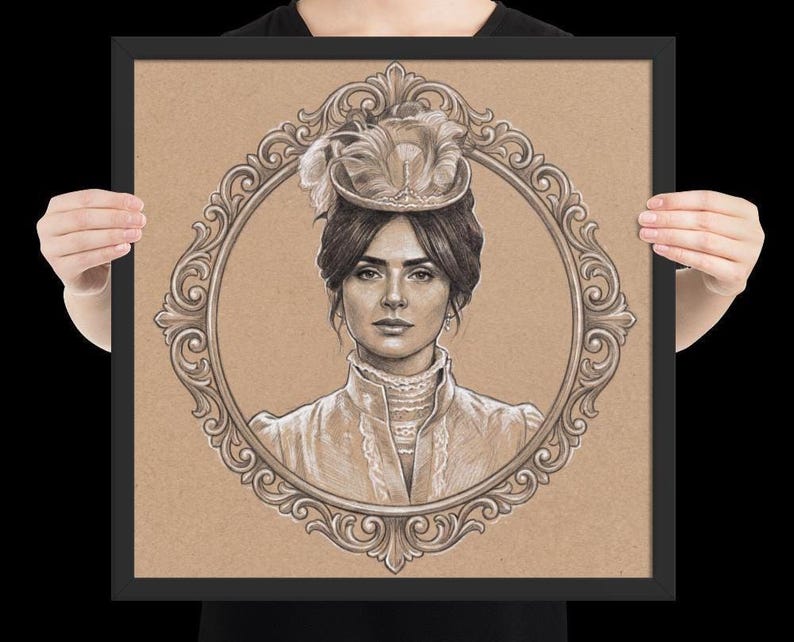 May include: A framed pencil drawing of a woman in a vintage hat and dress, set within an ornate oval frame. The artwork is in sepia tones, with the woman's portrait centered against a tan background. The frame is black.