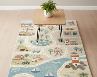 May include: A rectangular area rug featuring a colorful town and coastal map design with roads, a lighthouse, a bridge, vehicles, trees, and buildings in shades of blue, orange, green, and beige. The rug includes the text ARIYA RUG at the bottom.