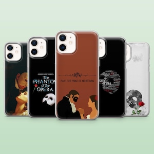 May include: A collection of phone cases featuring designs inspired by the musical "The Phantom of the Opera." The cases display various scenes and text, including "The Phantom of the Opera" and "Past the Point of No Return."