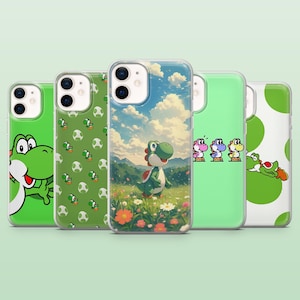 May include: Five phone cases with various designs featuring the character Yoshi. The cases are green, with images of Yoshi, eggs, and a scenic background. The cases are made of a clear, glossy material.